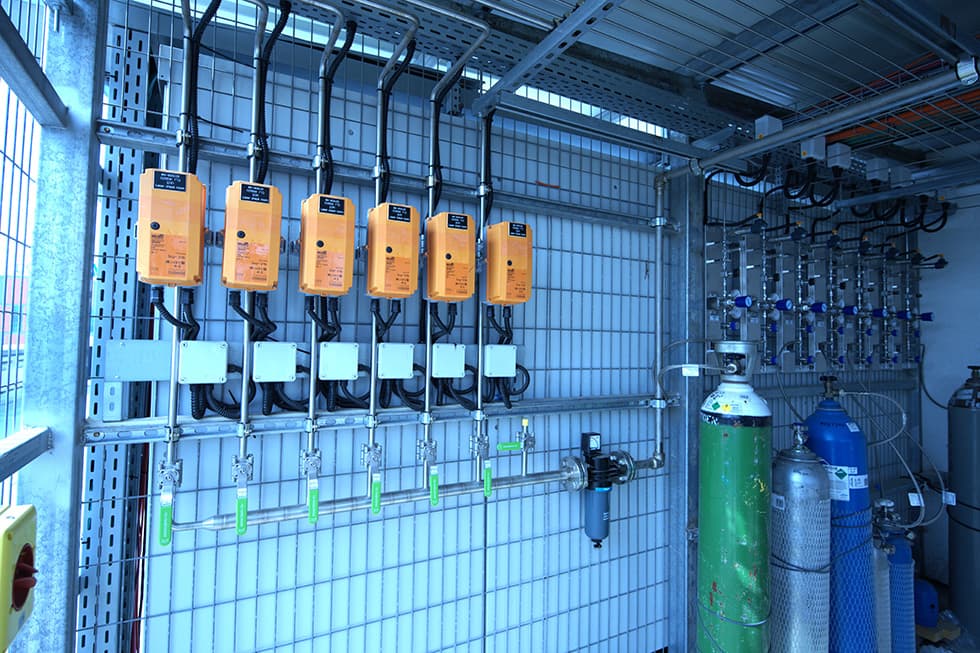Gas cabinet with orange detectors and gas cylinders